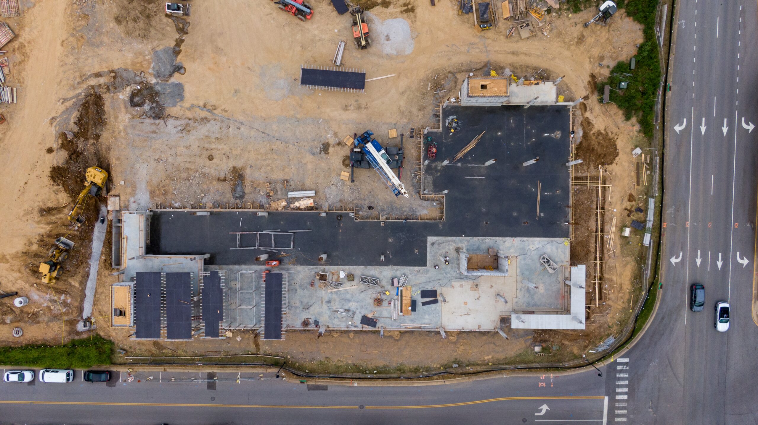 Aerial view of a vast commercial building construction site.